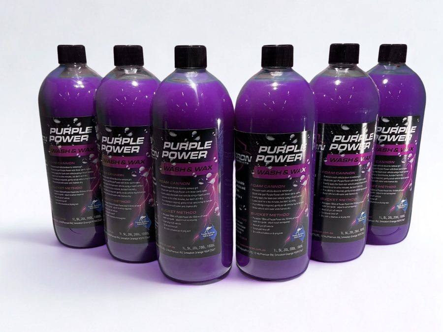 Multiple bottles of Omikron Purple Power Wash & Wax 1L arranged in a row on a white background