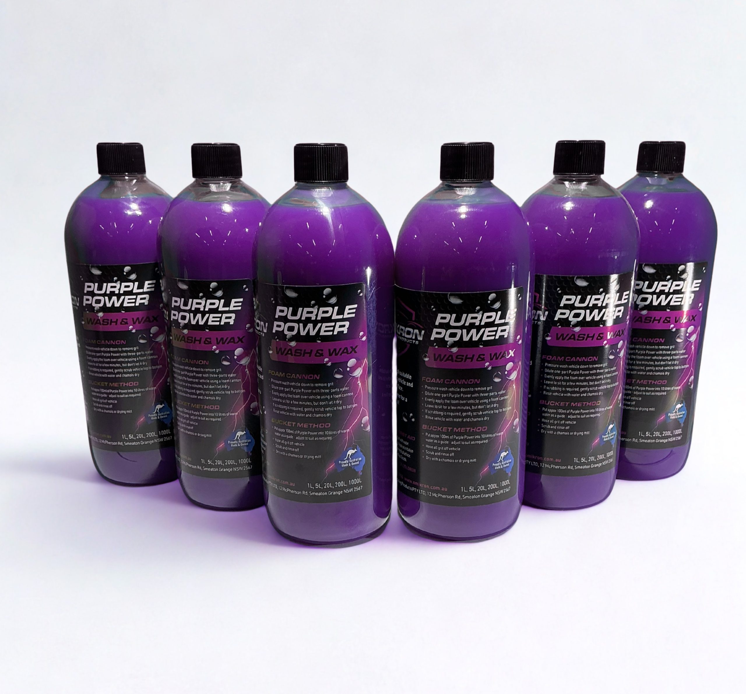 Multiple bottles of Omikron Purple Power Wash & Wax 1L arranged in a row on a white background