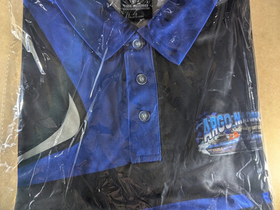 Folded Argo Marine Shepparton polo shirt in protective bag showing collar and chest logo.